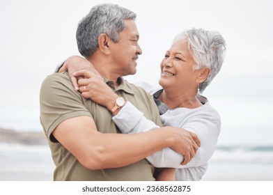 Senior couple, love and hug at beach for holiday, vacation or freedom to travel in retirement together. Happy man, elderly woman and embrace at ocean for trust, loyalty or relax with marriage partner - Powered by Shutterstock