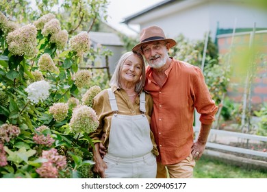 Senior couple in love posing together in their garden. - Powered by Shutterstock