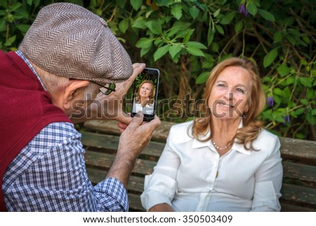 Similar – Woman taking selfie with older mother in wheelchair