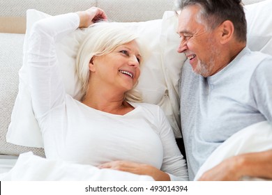 Senior Couple Lying In Bed Together
