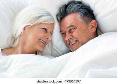 Senior Couple Lying In Bed Together
