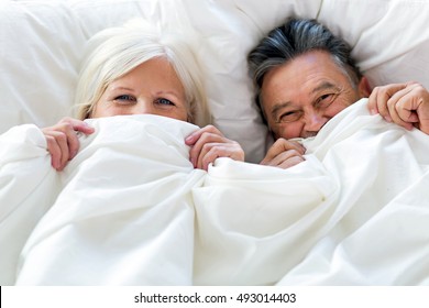 Senior couple lying in bed together
 - Powered by Shutterstock