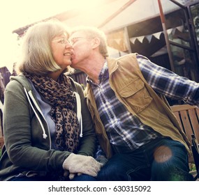 Senior Couple Man Giving Woman A Cheek Kiss