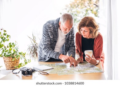 Senior Couple With Map At Home, Making Plans.