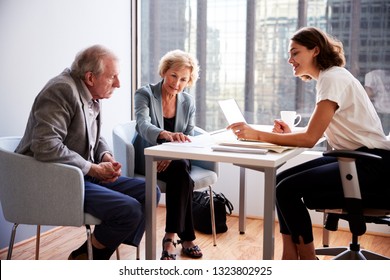 Senior Couple Meeting With Female Financial Advisor In Office