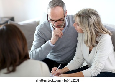 Senior Couple Meeting Financial Adviser For Investment