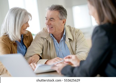 Senior Couple Meeting Financial Adviser For Investment                