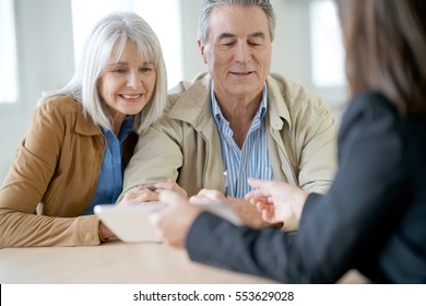 Senior Couple Meeting Financial Adviser For Investment                