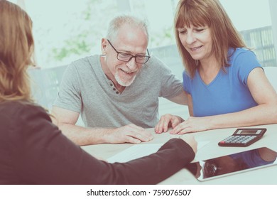 Senior Couple Meeting Financial Adviser For Investment