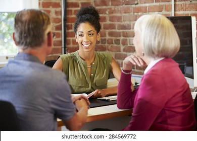 Senior Couple Meeting With Financial Advisor In Office