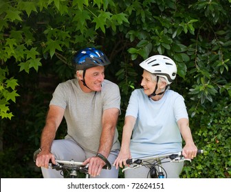 Senior Couple Mountain Biking Outside