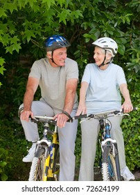 Senior Couple Mountain Biking Outside