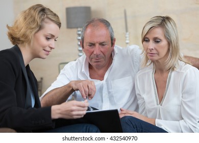 senior couple negotiating with businesswoman for new investment - Shutterstock ID 432540970