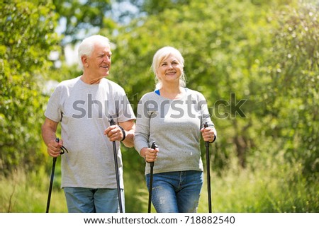 Senior couple nordic walking in park
