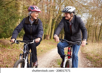 Senior Couple On Cycle Ride In Winter Countryside