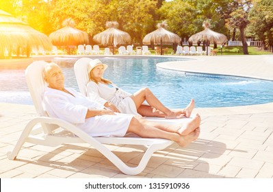 Senior Couple On Spa Vacation On Deckchair