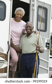 Senior Couple On Steps Of A Caravan