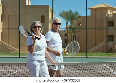 Senior Couple On Tennis Court