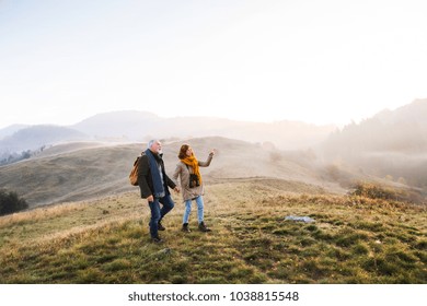 Senior couple on a walk in an autumn nature. - Powered by Shutterstock