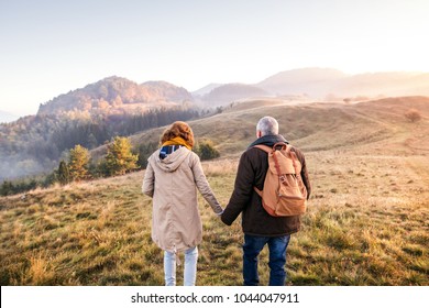 Senior couple on a walk in an autumn nature.