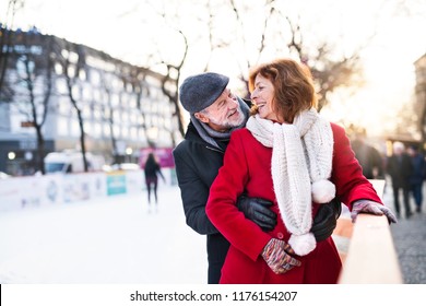 Senior Couple On A Walk In A City In Winter.