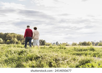 Senior couple on a walk in rural landscape - Powered by Shutterstock