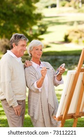 Senior Couple Painting In The Park