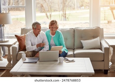 Senior couple, paperwork and reading on couch with laptop, smile or point for taxes in home. Old man, woman and computer with documents for compliance, audit or investment report for financial review - Powered by Shutterstock