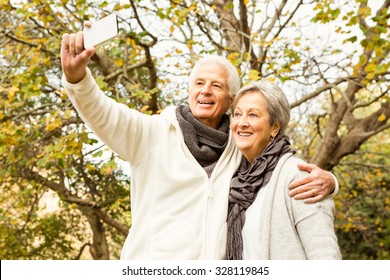 Senior couple in the park on an autumns day - Powered by Shutterstock