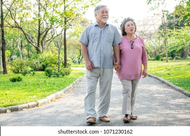 Senior Couple In Park Portrait. Chinese Old Couple In Park, Relaxing, Smiling.