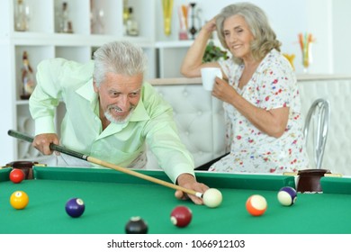 Senior Couple Playing Billiard