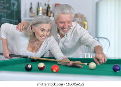 Senior Couple Playing Billiard