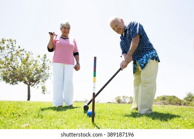 Senior Couple Playing Croquet, Outdoors