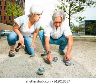 Senior Couple Playing A Game Of Boule