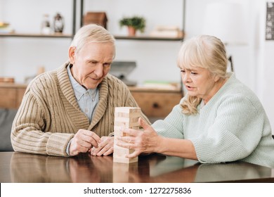 Senior Couple Playing Jenga Game At Home