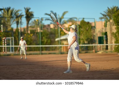 Senior Couple Playing Tennis