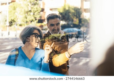 Senior couple pointing location while navigating urban travel