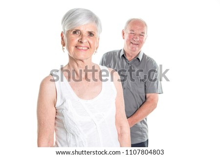 Senior couple posing on studio white background