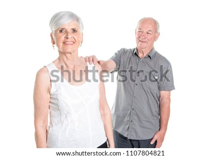 Senior couple posing on studio white background