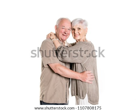 Senior couple posing on studio white background