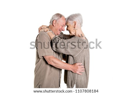 Senior couple posing on studio white background