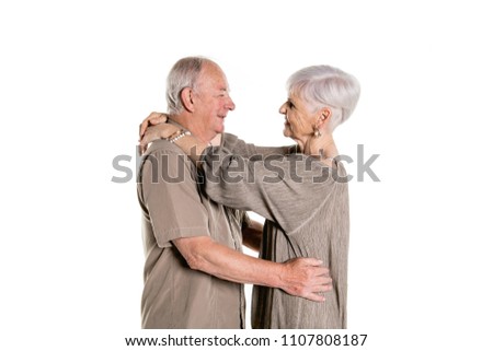 Senior couple posing on studio white background