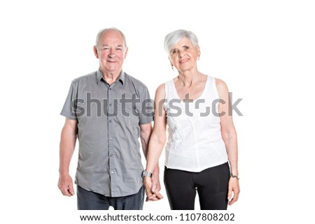 Senior couple posing on studio white background