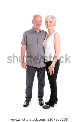 Senior couple posing on studio white background