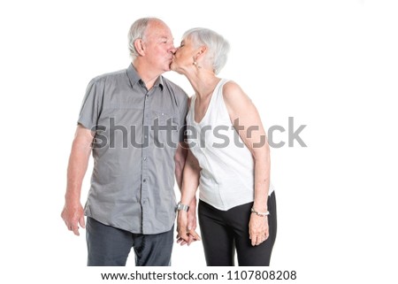 Senior couple posing on studio white background