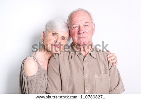 Senior couple posing on studio white background