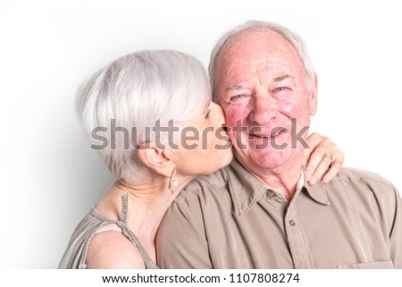 Senior couple posing on studio white background