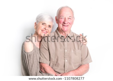 Senior couple posing on studio white background