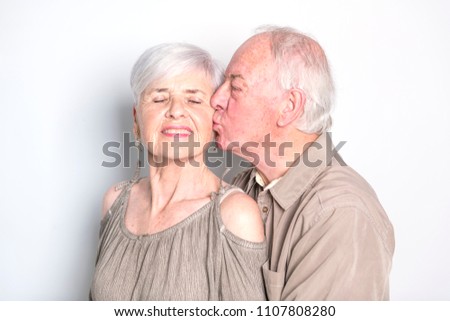 Senior couple posing on studio white background