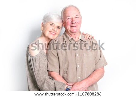Senior couple posing on studio white background
